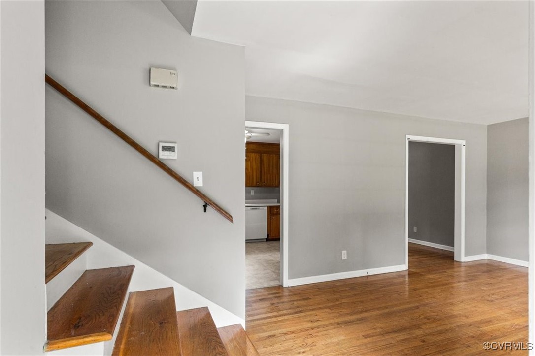 Stairway featuring wood finished floors and basebo