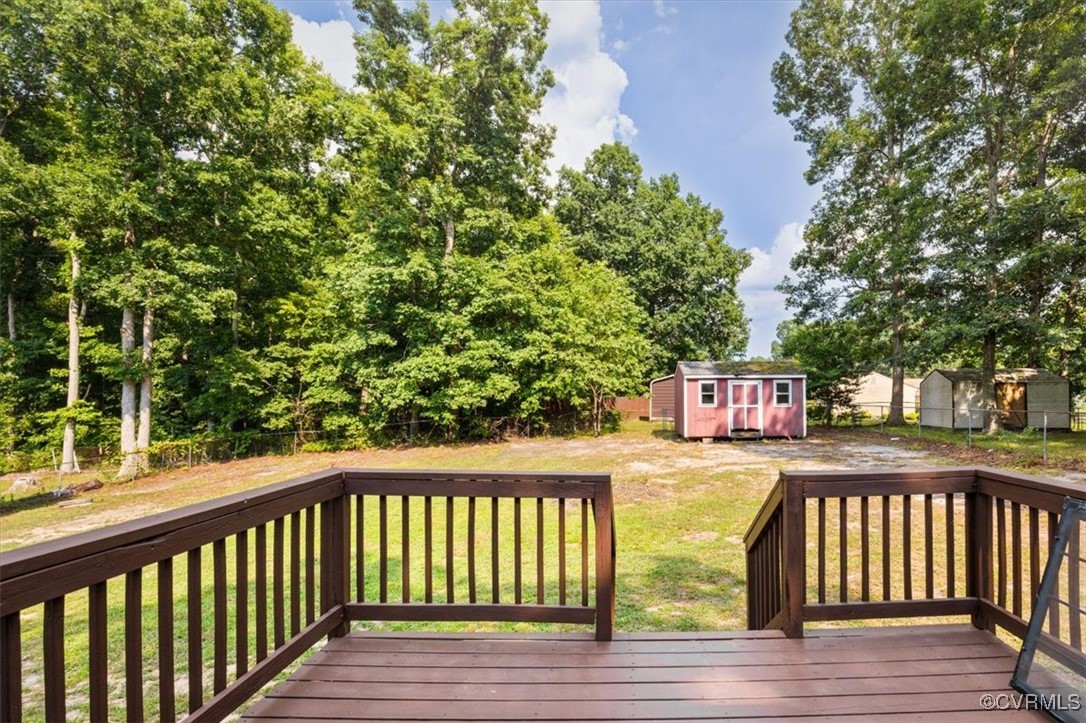 7801 Bull Hill Road Prince George, VA 23875 - Photo 49 of 49 Deck with a storage shed and a fenced backyard