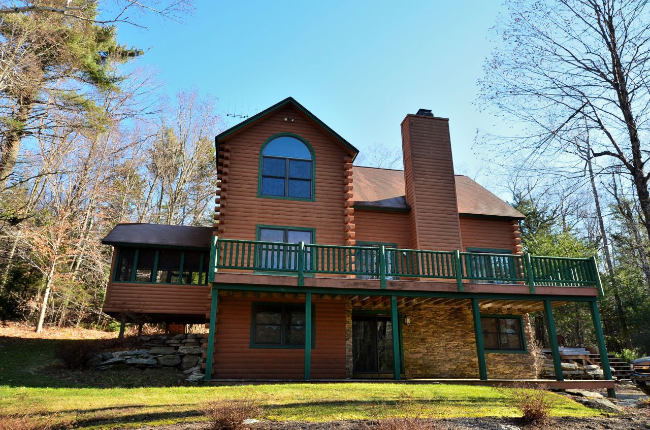 697 Woodmere Road Becket, MA 01223 - Photo 2 of 23 a view of a house with a swimming pool