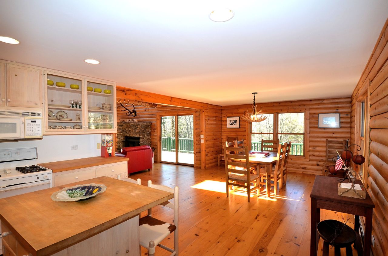 697 Woodmere Road Becket, MA 01223 - Photo 12 of 23 a living room with furniture and floor to ceiling windows