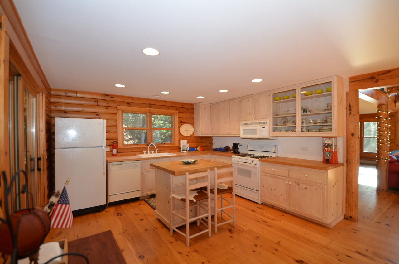 697 Woodmere Road Becket, MA 01223 - Photo 13 of 23 a kitchen with a sink dining table and chairs