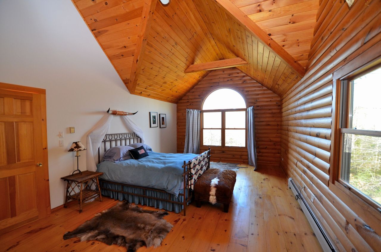 697 Woodmere Road Becket, MA 01223 - Photo 15 of 23 a living room with furniture a wooden floor and a large window