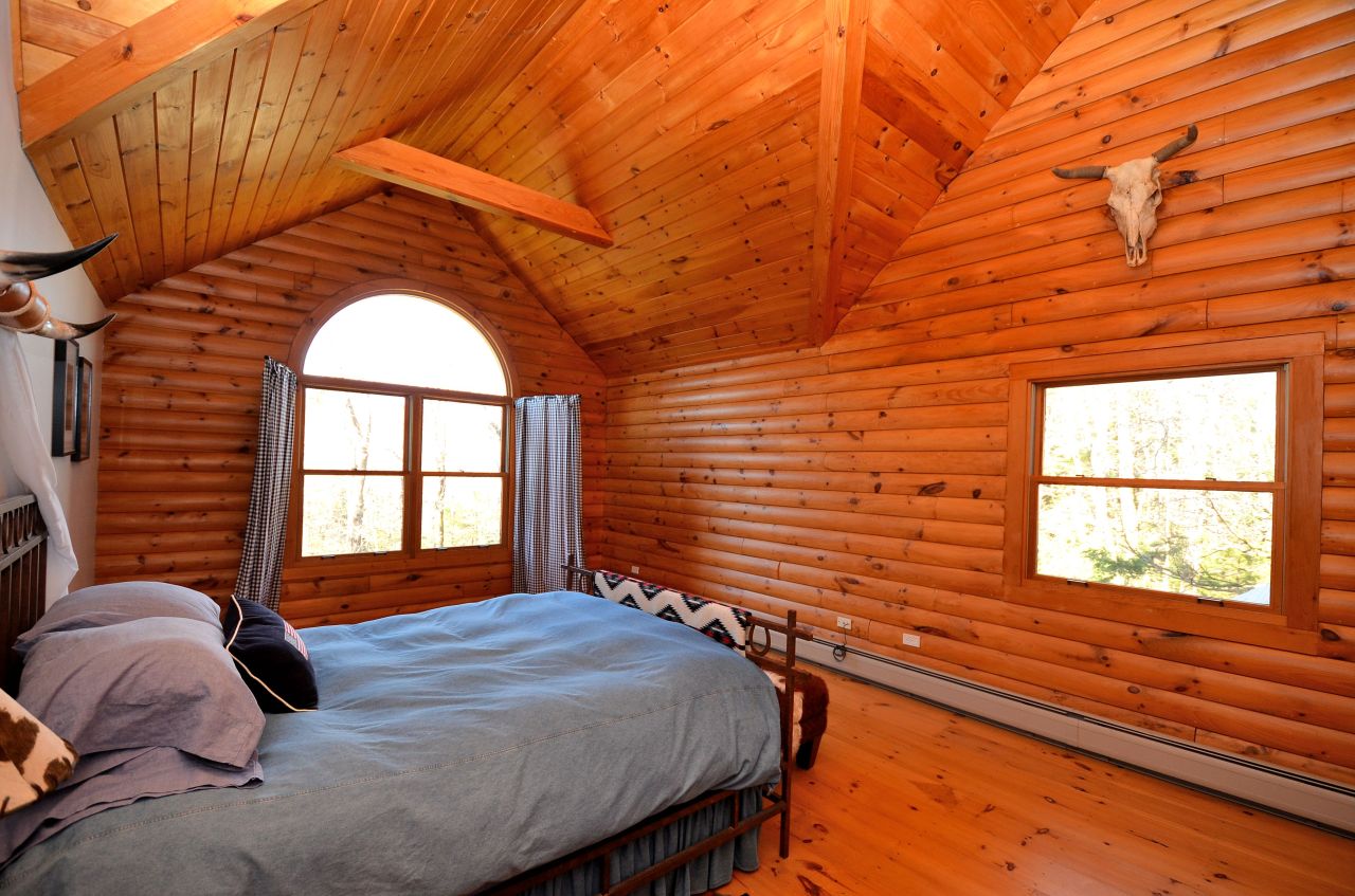 697 Woodmere Road Becket, MA 01223 - Photo 16 of 23 a bedroom with a bed and a large window