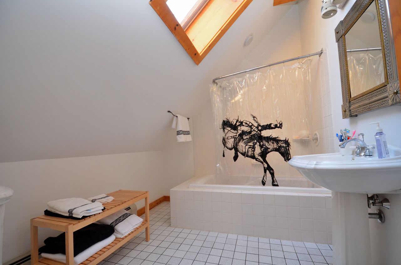 697 Woodmere Road Becket, MA 01223 - Photo 17 of 23 a bathroom with a tub sink and mirror