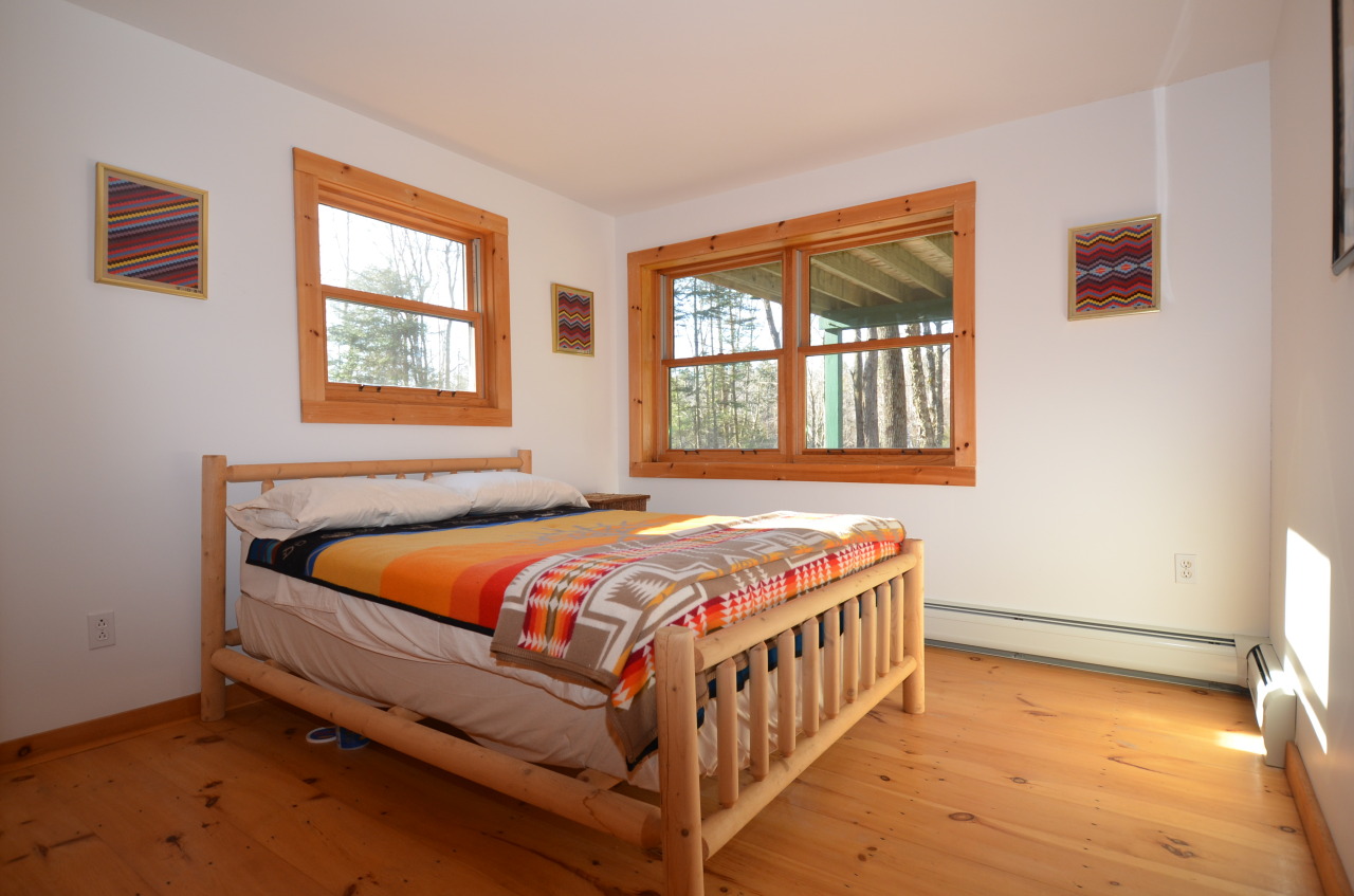 697 Woodmere Road Becket, MA 01223 - Photo 18 of 23 a bedroom with a bed and a window