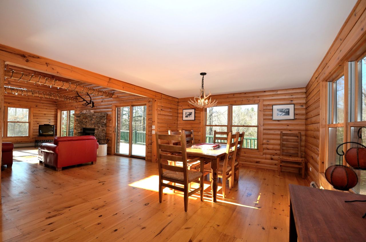 697 Woodmere Road Becket, MA 01223 - Photo 10 of 23 a dining room with furniture a chandelier and wooden floor