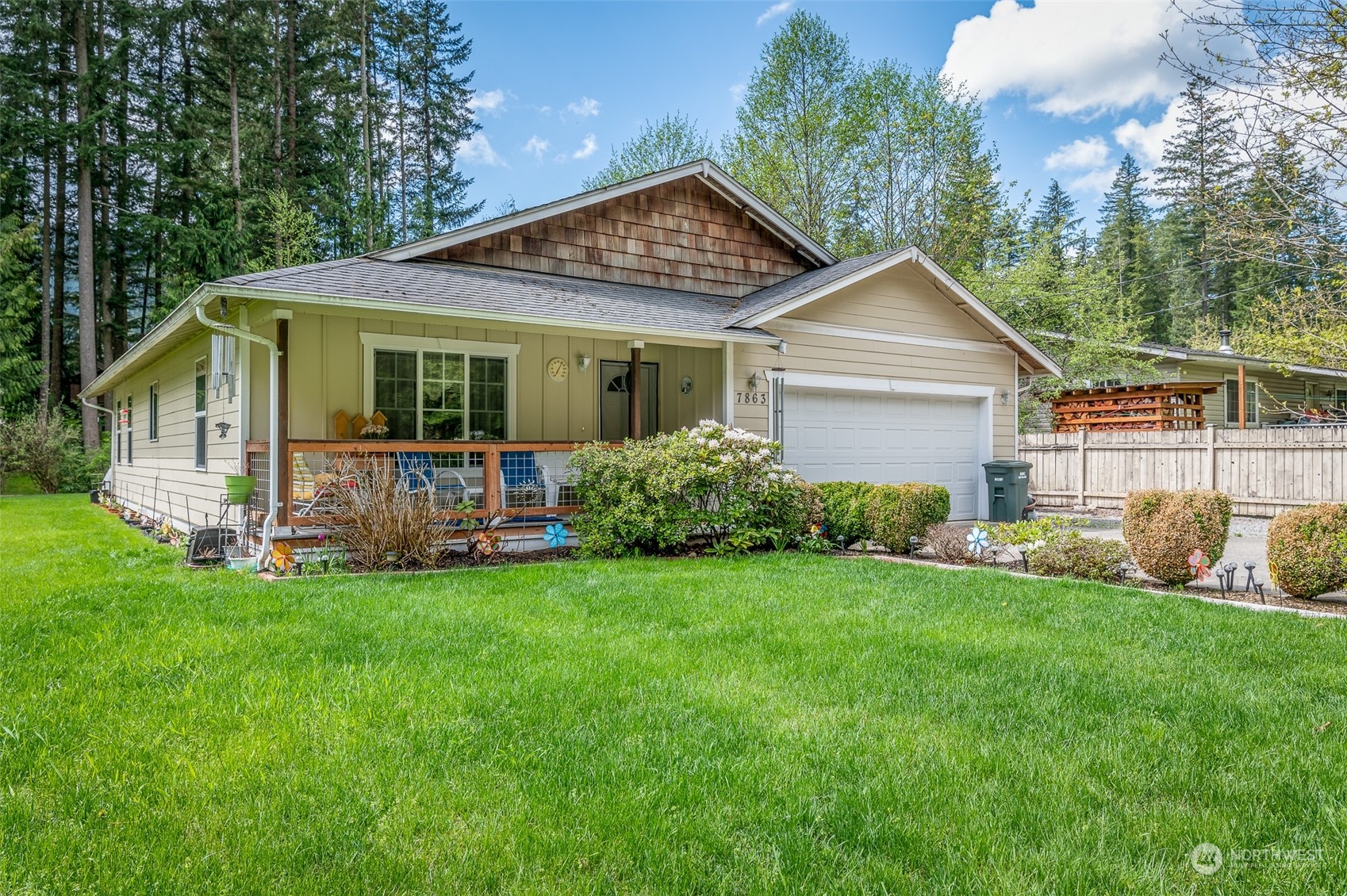 a view of a house with a yard and sitting area