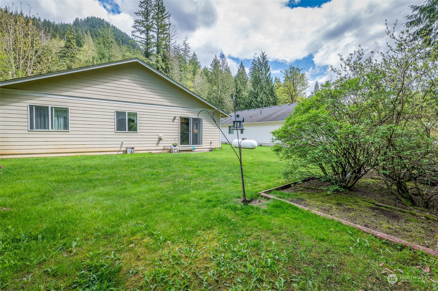 7863 Santa Fe Trail Maple Falls, WA 98266 - Photo 27 of 30 a backyard of a house with plants and large trees