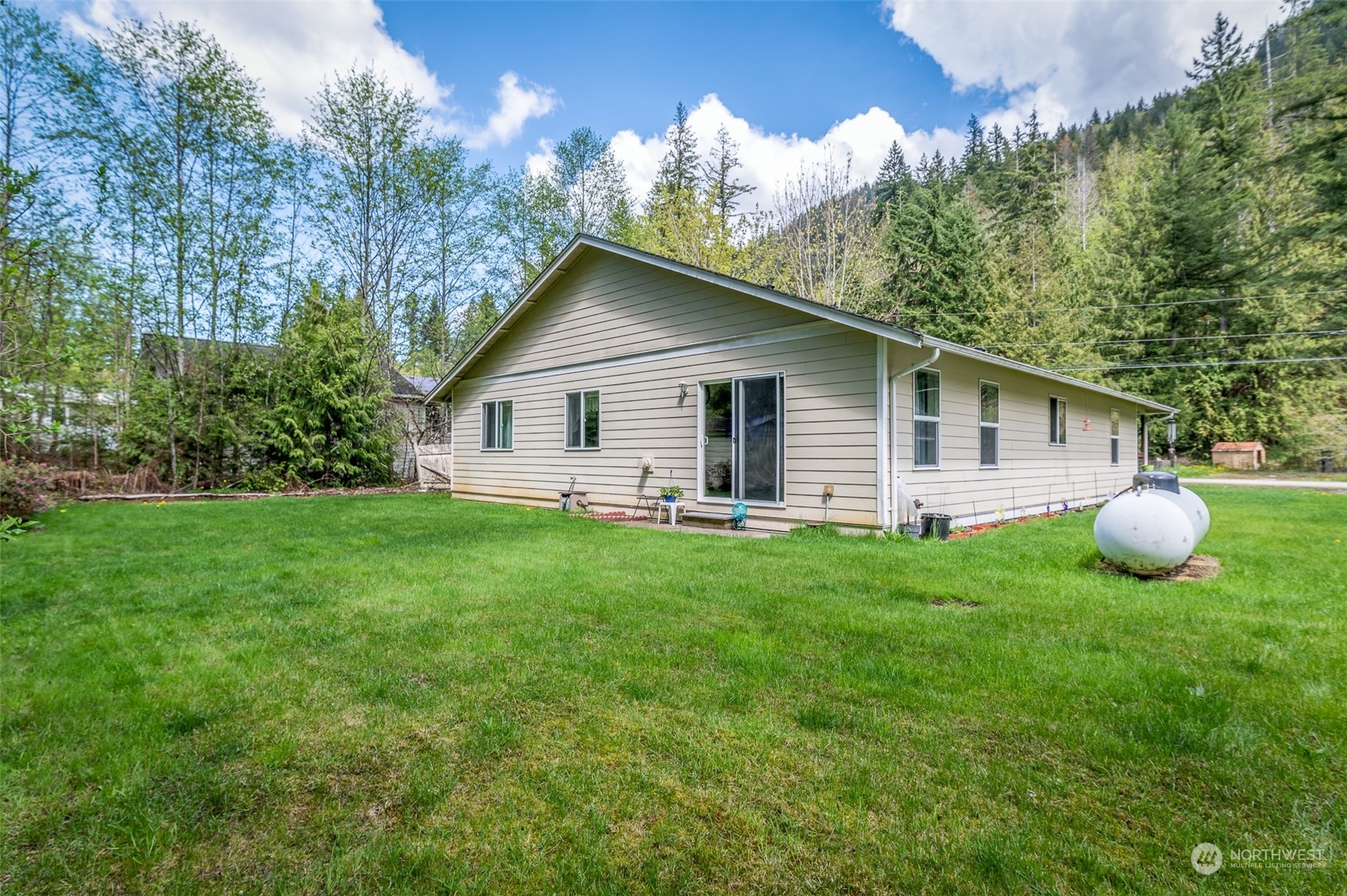 7863 Santa Fe Trail Maple Falls, WA 98266 - Photo 28 of 30 a view of a house with a backyard and patio