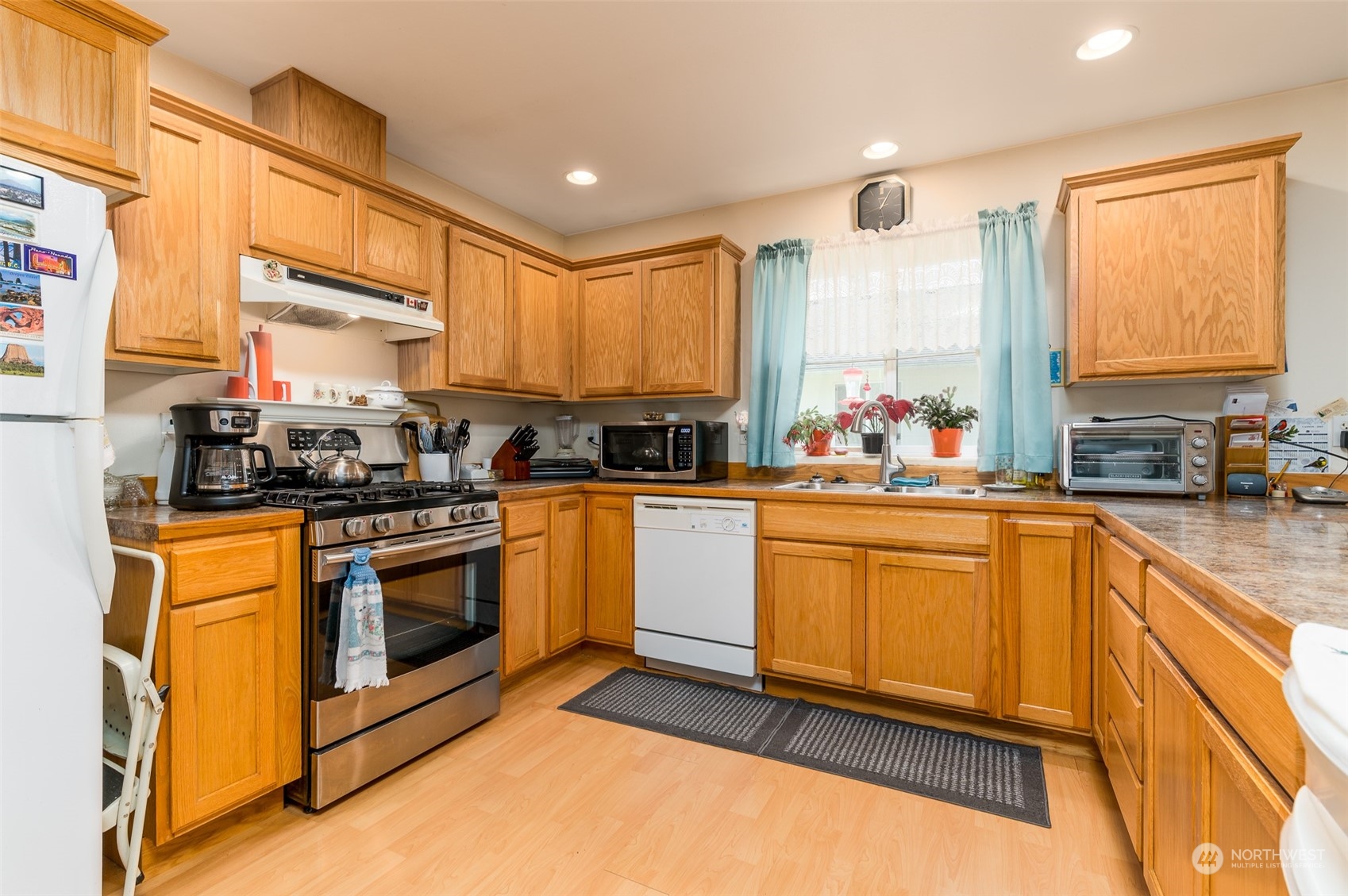 7863 Santa Fe Trail Maple Falls, WA 98266 - Photo 7 of 30 a kitchen with stainless steel appliances granite countertop a stove a sink and a microwave