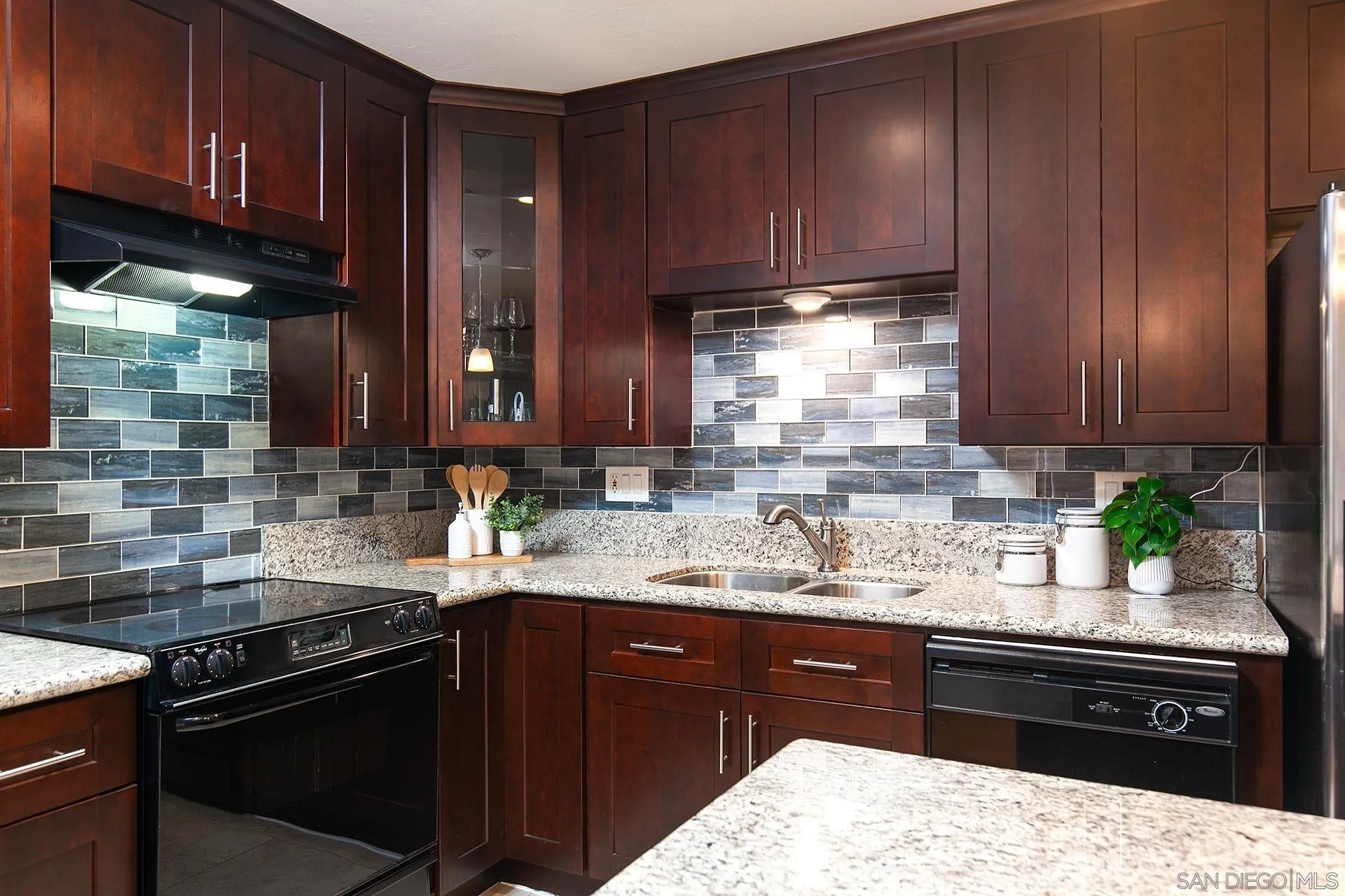 4878 Pescadero Avenue, Unit 103 San Diego, CA 92107 - Photo 18 of 72 a kitchen with a sink and wooden cabinets