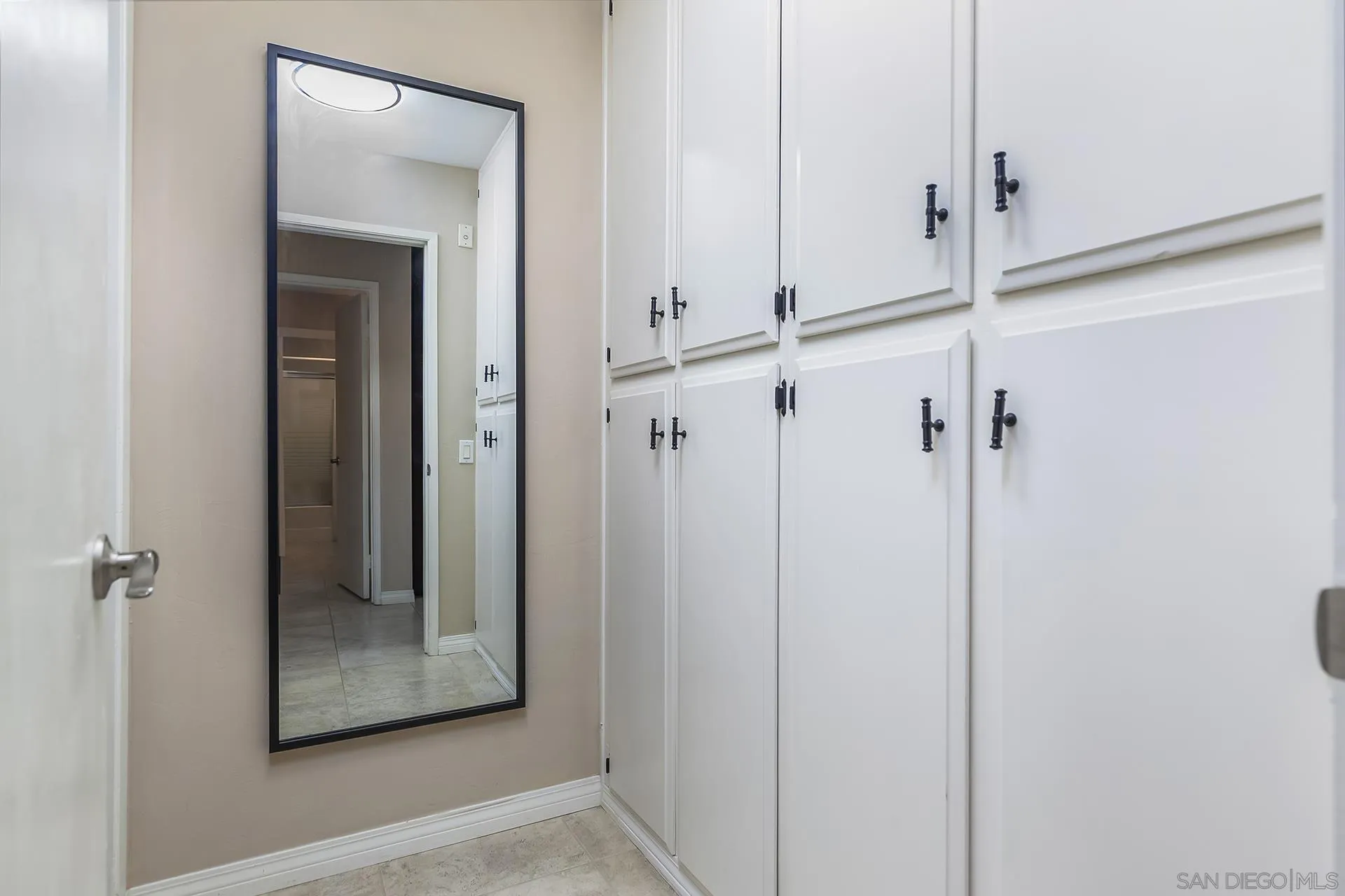 4878 Pescadero Avenue, Unit 103 San Diego, CA 92107 - Photo 22 of 72 a view of a hallway with a glass door and mirror