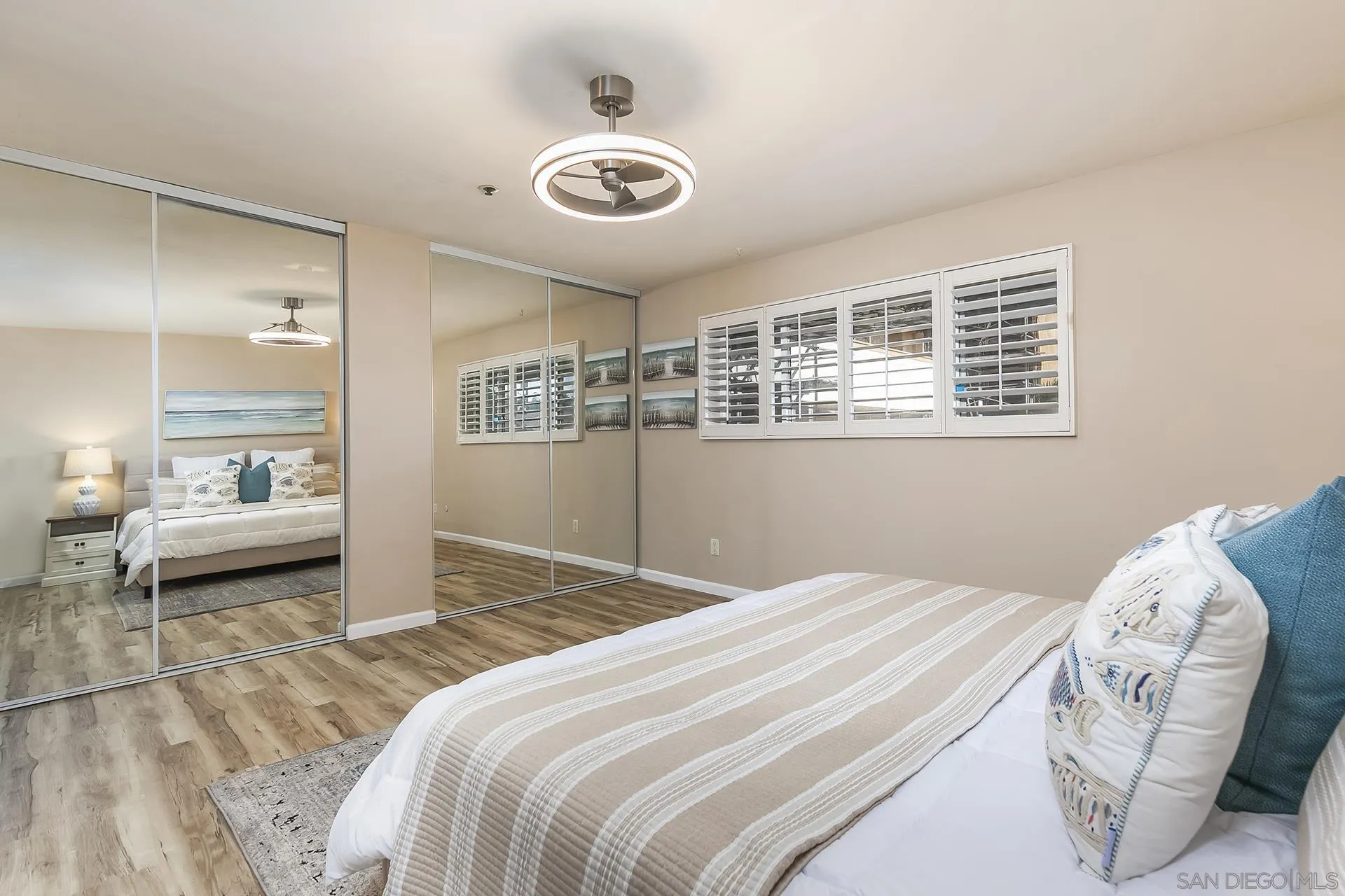 4878 Pescadero Avenue, Unit 103 San Diego, CA 92107 - Photo 25 of 72 a bedroom with a bed and a large mirror