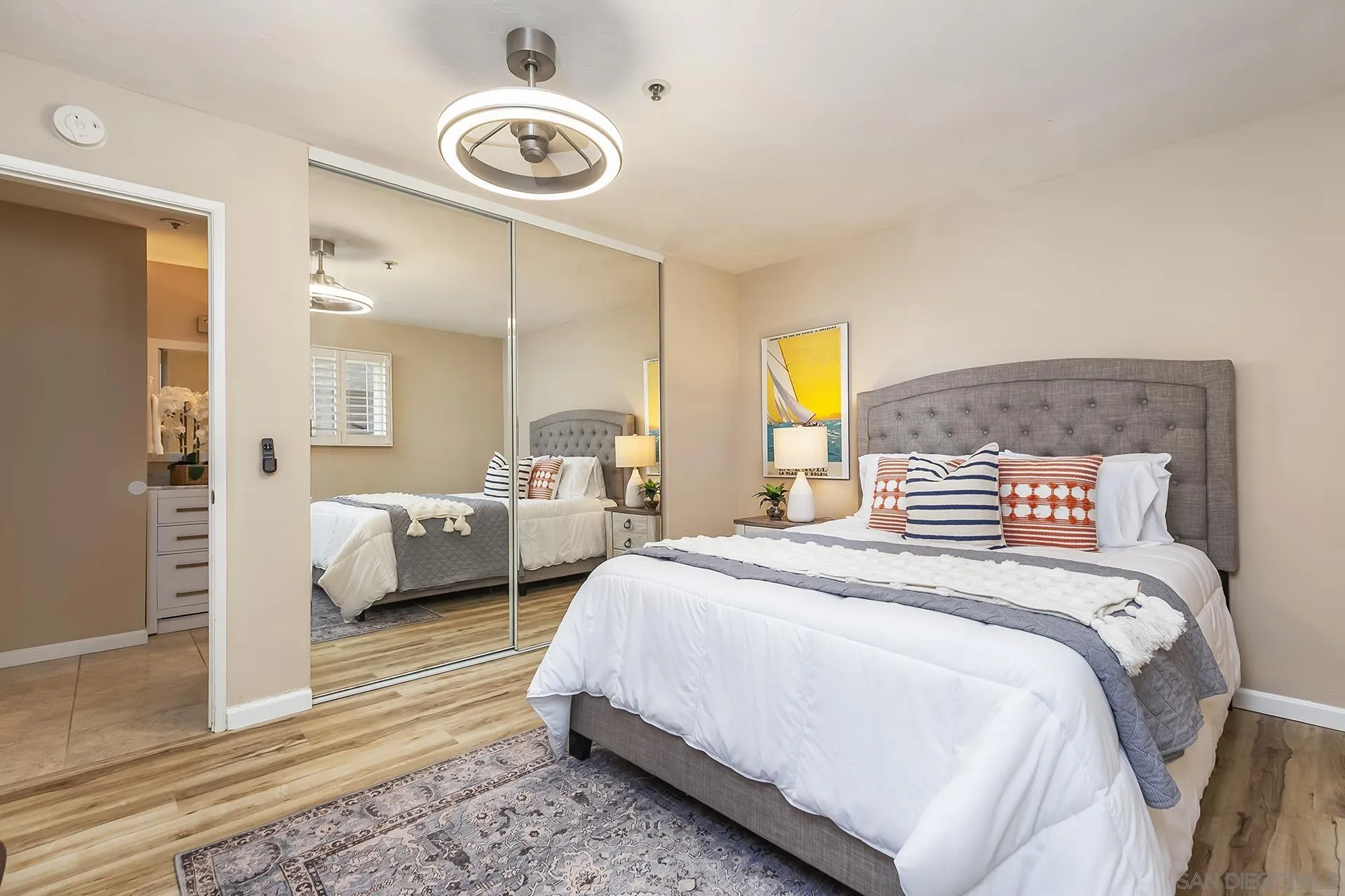 4878 Pescadero Avenue, Unit 103 San Diego, CA 92107 - Photo 31 of 72 a bedroom with a bed and a large mirror