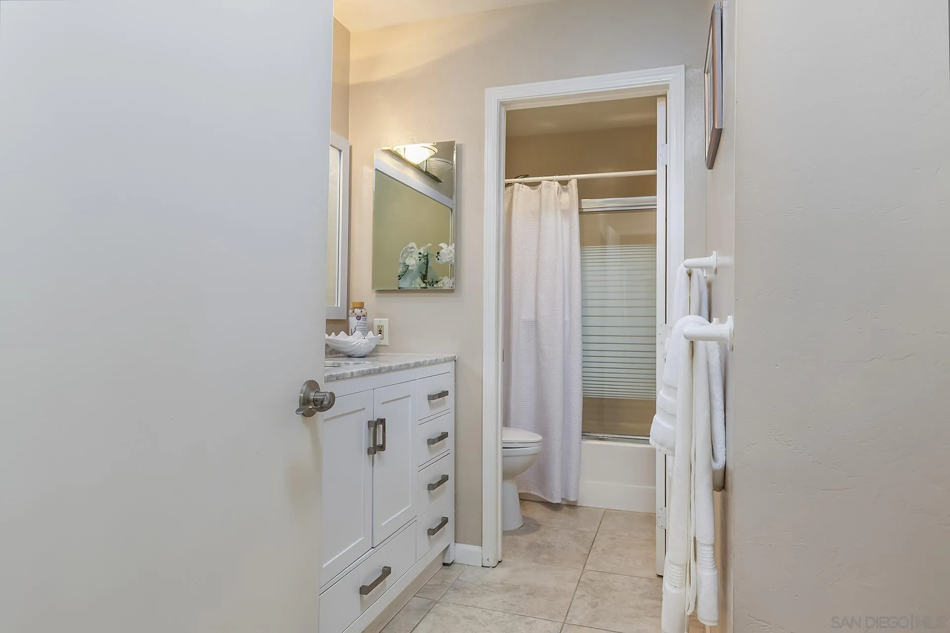 4878 Pescadero Avenue, Unit 103 San Diego, CA 92107 - Photo 32 of 72 a bathroom with a sink and a mirror
