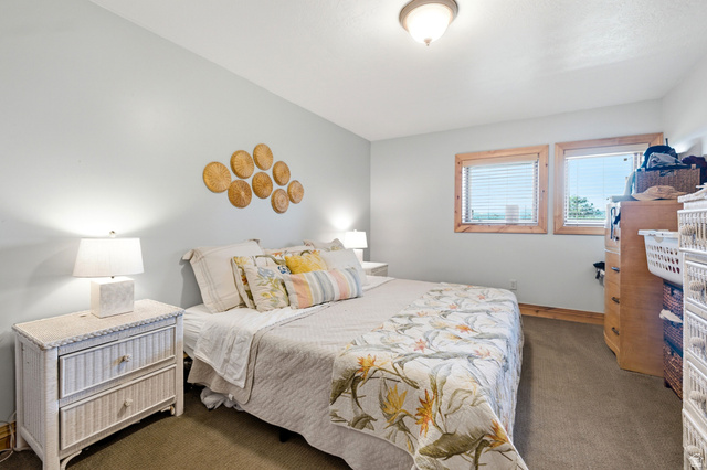 335 Bern Way Midway, UT 84049 - Photo 66 of 88 Bedroom featuring two windows with wood-trim framing and blinds, a ceiling-mounted light fixture, and carpet flooring