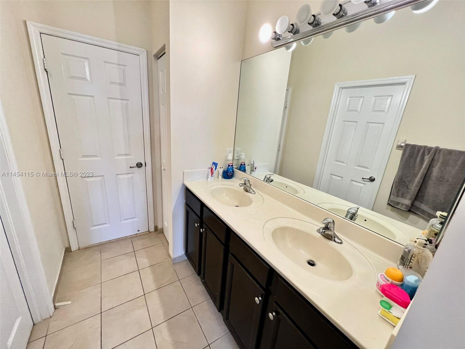 17182 Southwest 92nd Street Miami, FL 33196 - Photo 13 of 46 a spacious bathroom with a sink a mirror and a shower
