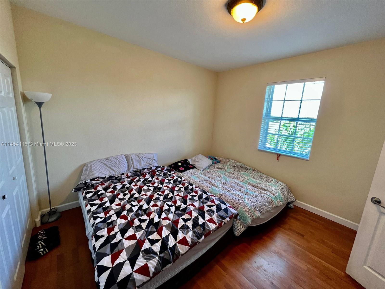 17182 Southwest 92nd Street Miami, FL 33196 - Photo 15 of 46 a bedroom with bed and window