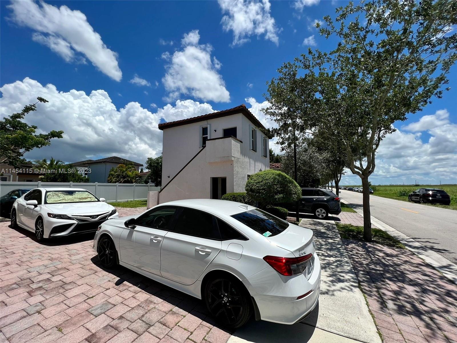 17182 Southwest 92nd Street Miami, FL 33196 - Photo 17 of 46 a front view of a house with parking space