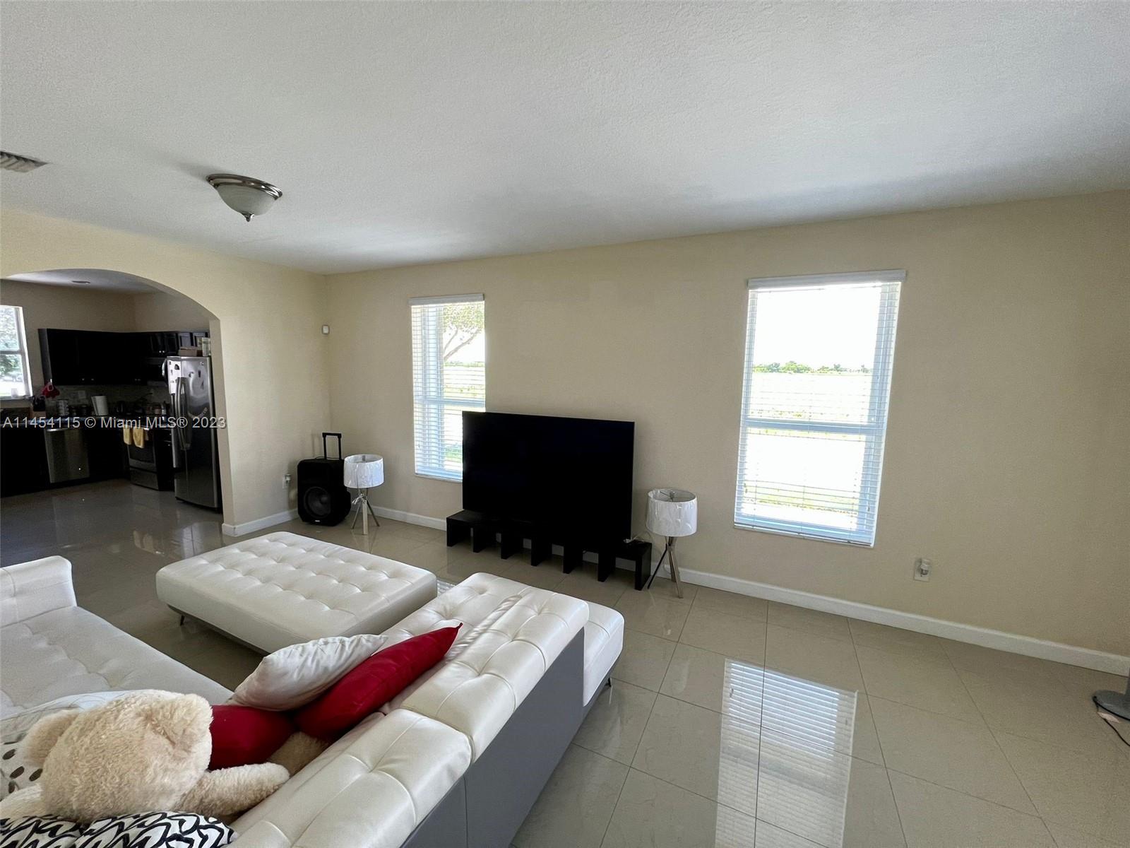 17182 Southwest 92nd Street Miami, FL 33196 - Photo 19 of 46 a living room with furniture and a flat screen tv