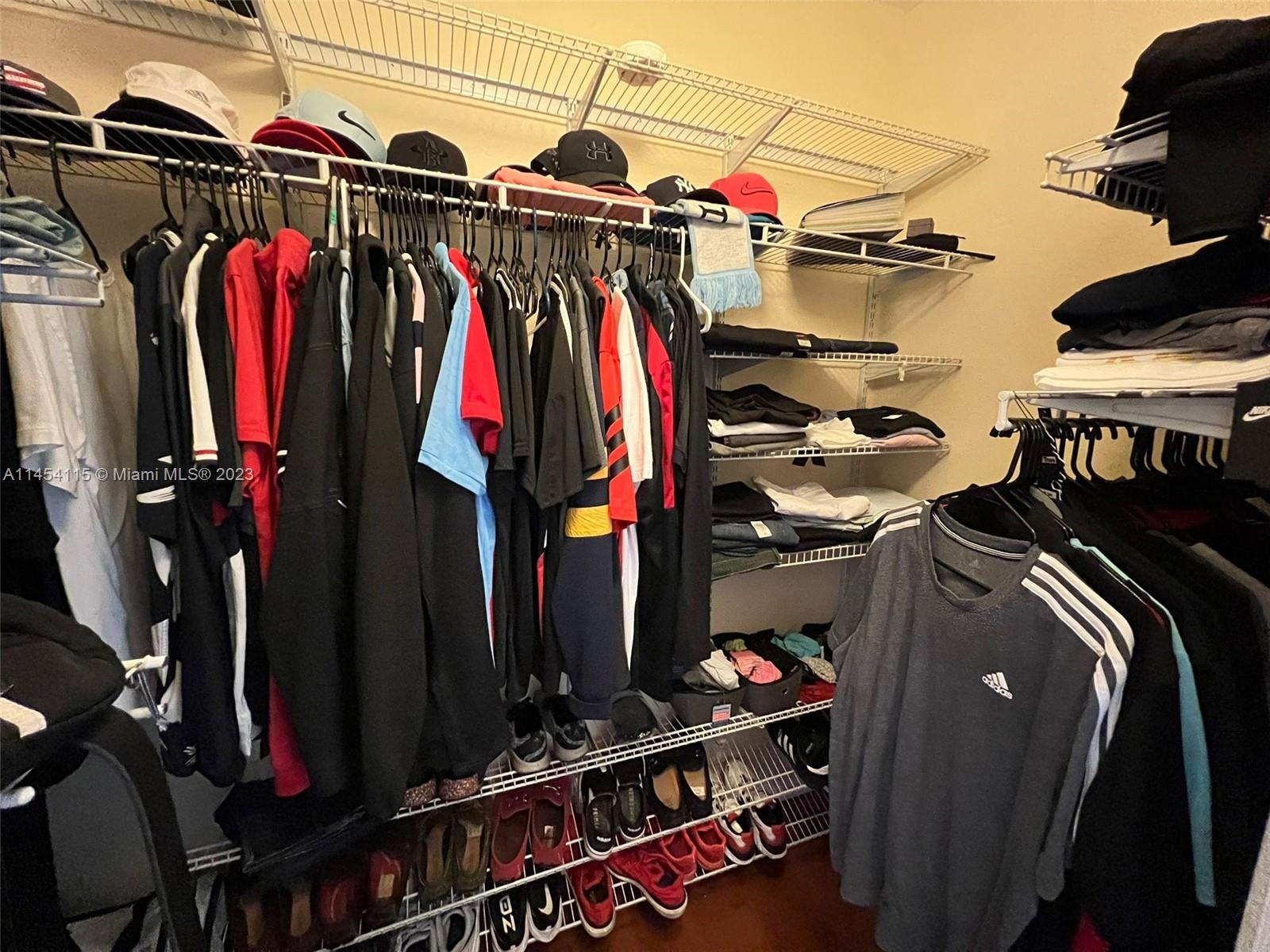 17182 Southwest 92nd Street Miami, FL 33196 - Photo 21 of 46 a view of walk in closet with clothes and shoes