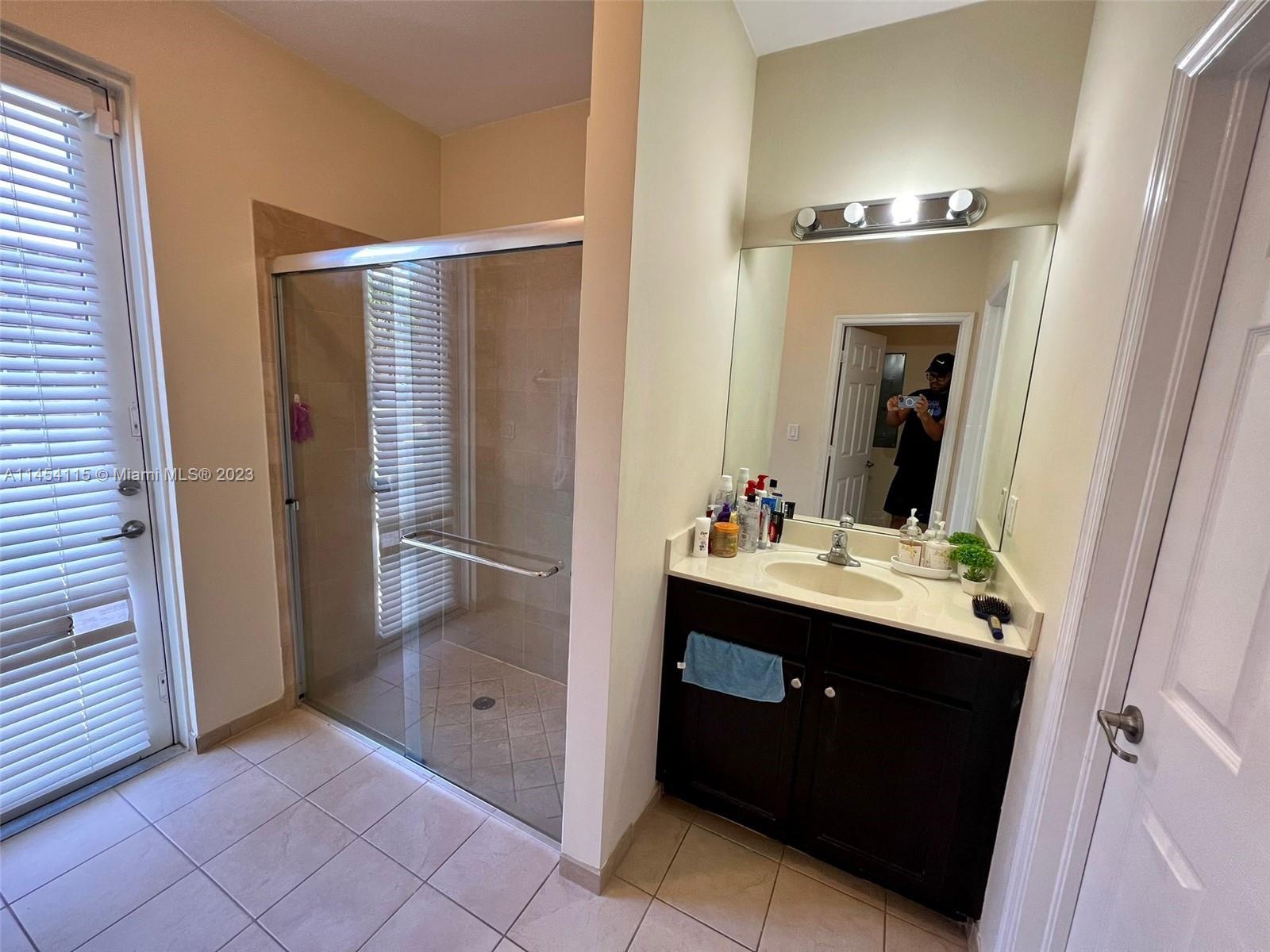 17182 Southwest 92nd Street Miami, FL 33196 - Photo 26 of 46 a bathroom with a sink and mirror