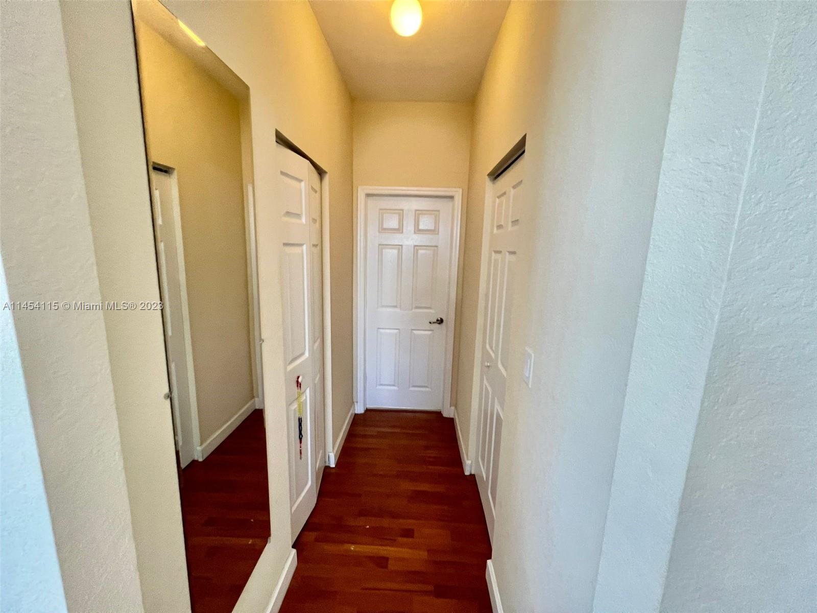 17182 Southwest 92nd Street Miami, FL 33196 - Photo 27 of 46 a view of a hallway with wooden floor and staircase