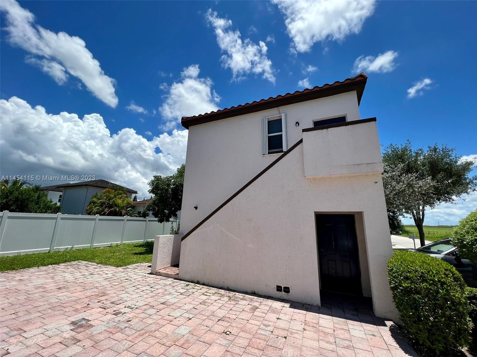 17182 Southwest 92nd Street Miami, FL 33196 - Photo 29 of 46 a backyard of a house with lots of green space