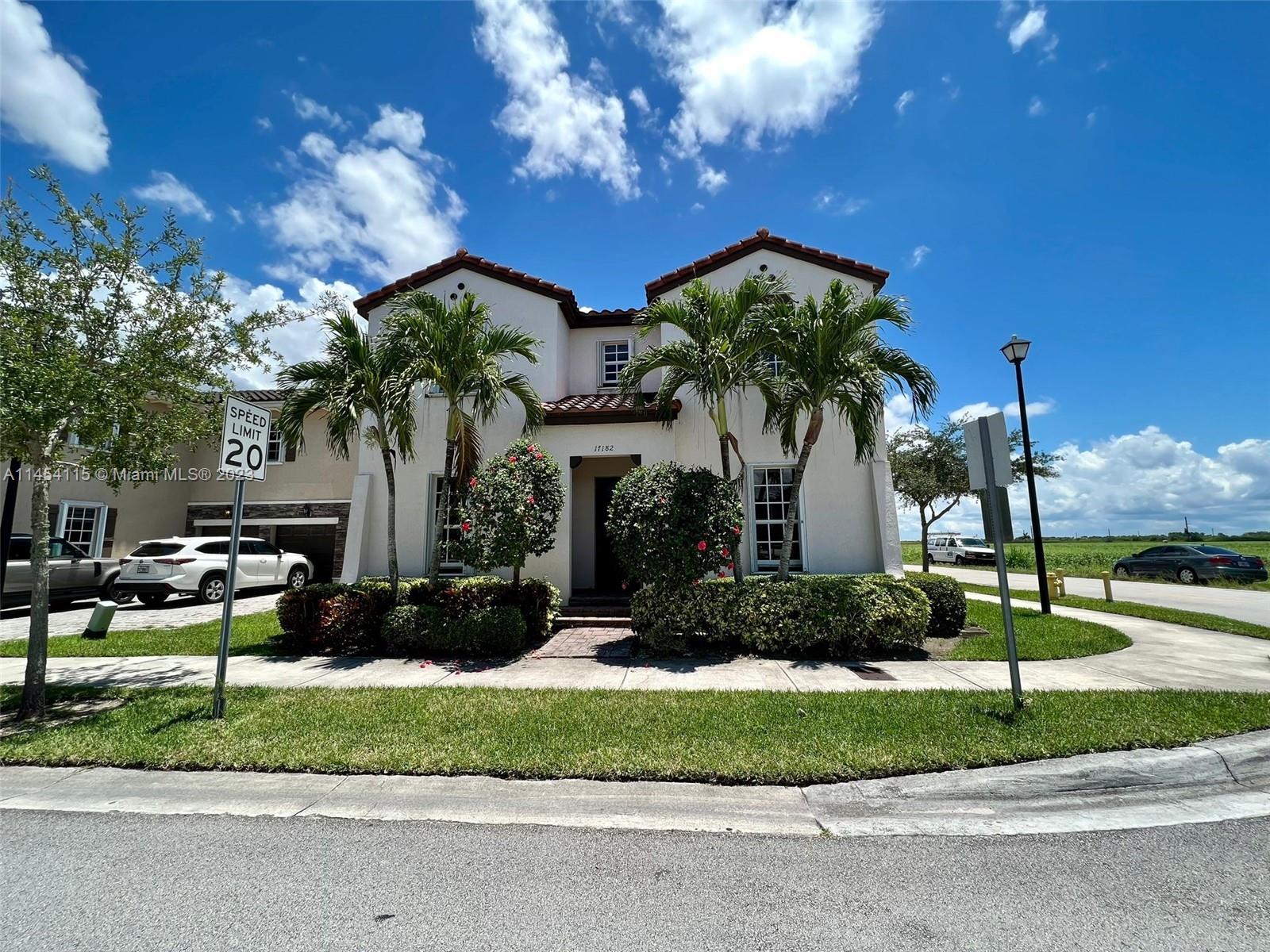 17182 Southwest 92nd Street Miami, FL 33196 - Photo 3 of 46 a front view of a house with a garden and entertaining space