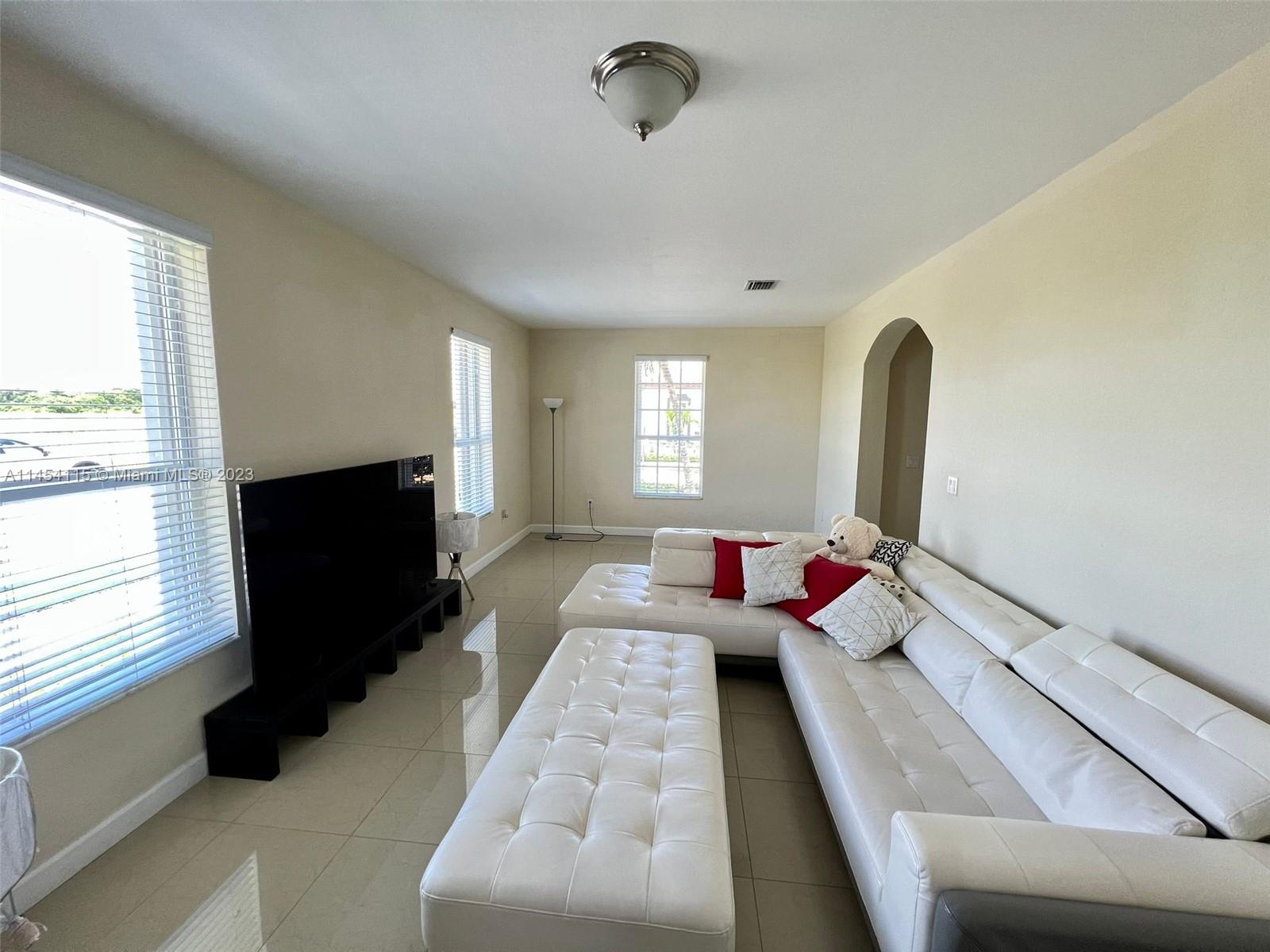 17182 Southwest 92nd Street Miami, FL 33196 - Photo 31 of 46 a bedroom with bed and window
