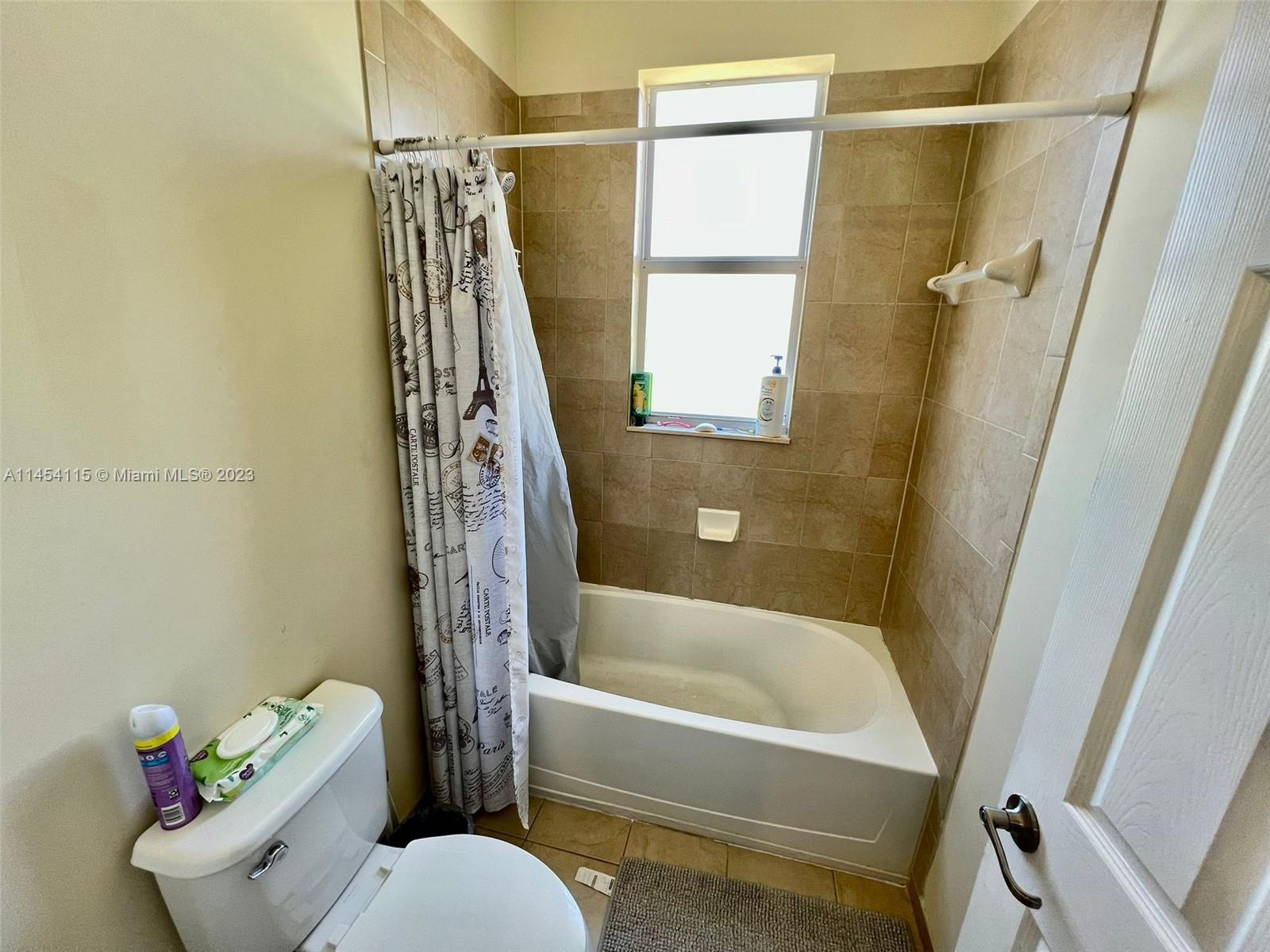 17182 Southwest 92nd Street Miami, FL 33196 - Photo 32 of 46 a bathroom with a shower a toilet and a bathtub
