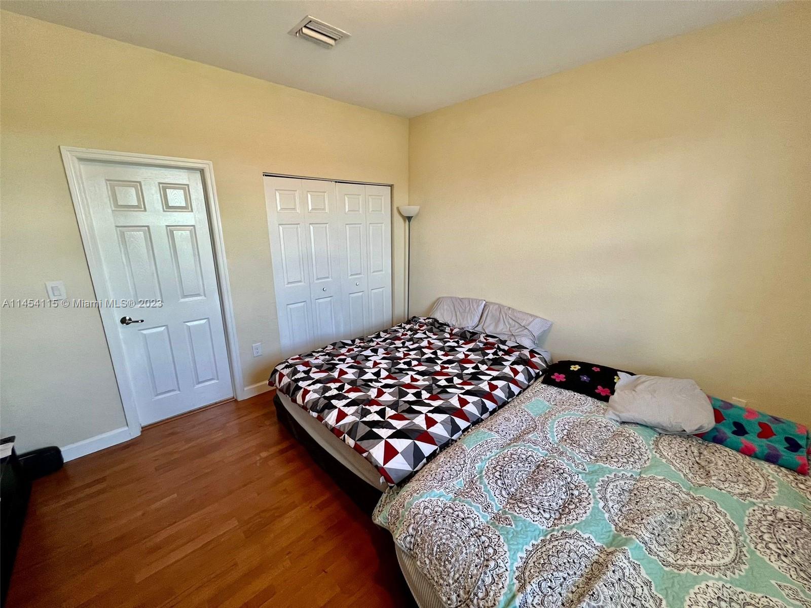 17182 Southwest 92nd Street Miami, FL 33196 - Photo 37 of 46 a bedroom with a bed and a dresser