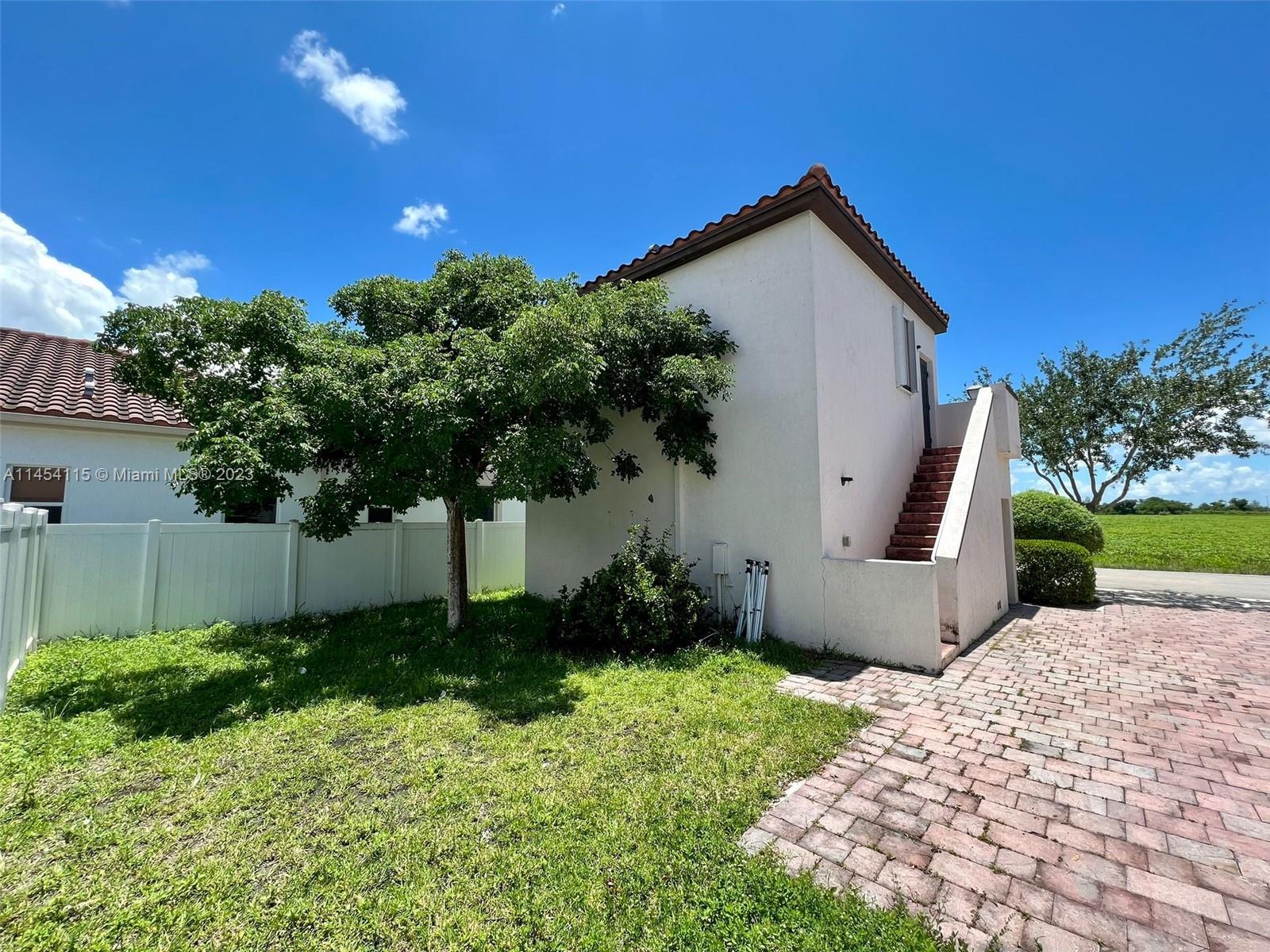 17182 Southwest 92nd Street Miami, FL 33196 - Photo 40 of 46 a front view of a house with garden