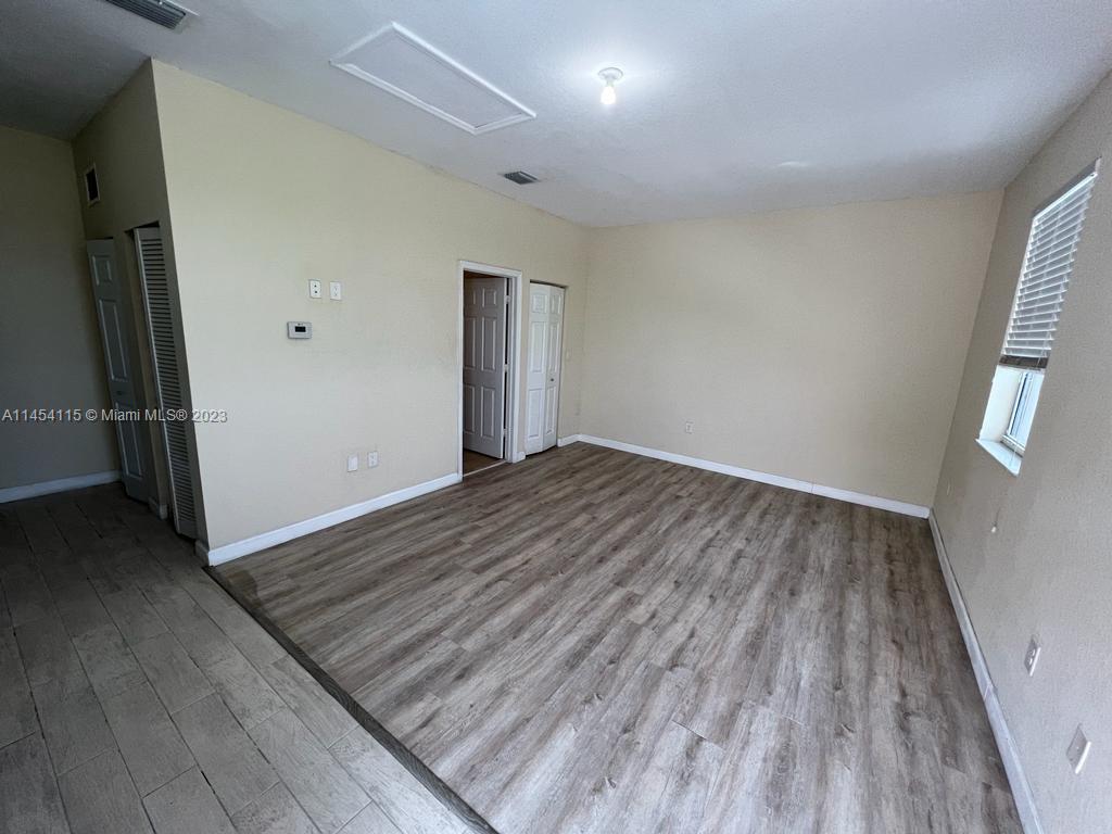 17182 Southwest 92nd Street Miami, FL 33196 - Photo 41 of 46 an empty room with wooden floor and a window