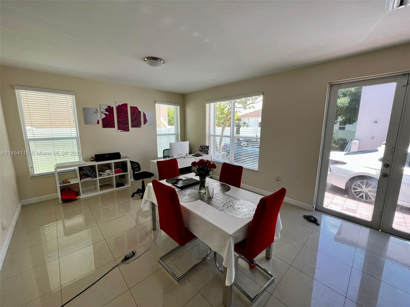 17182 Southwest 92nd Street Miami, FL 33196 - Photo 9 of 46 a living room with furniture a flat screen tv and a large window