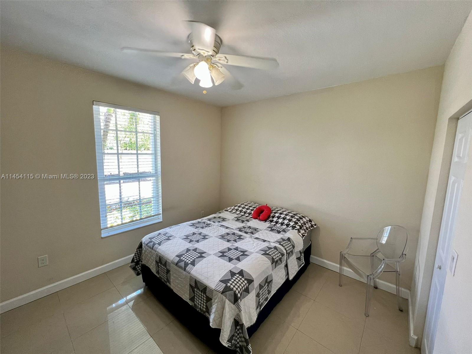 17182 Southwest 92nd Street Miami, FL 33196 - Photo 10 of 46 a bedroom with a bed and a window