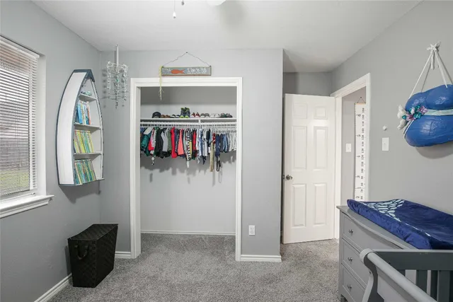 a spacious bedroom with a bed and a table in it