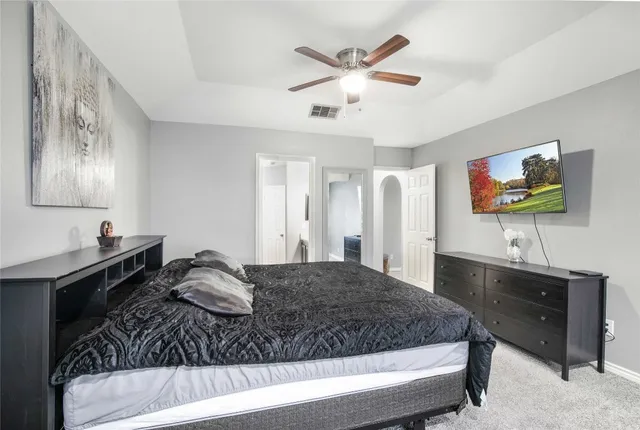 a view of a house with a yard and a large tree