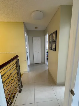 a bedroom with a bed and a lamp on the dresser