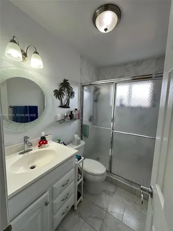 a bedroom with a bed and a ceiling fan