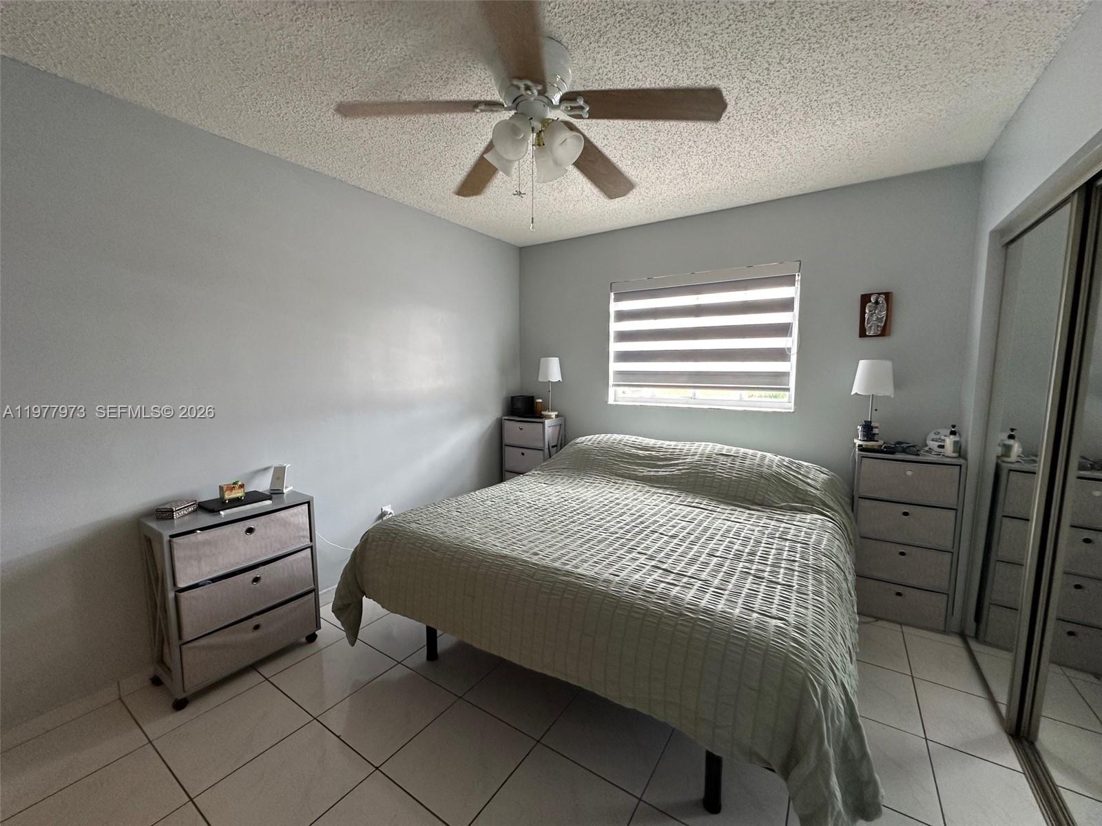 2385 West 69th Street, Unit 2385A Hialeah, FL 33016 - Photo 17 of 22 a bedroom with a bed and a ceiling fan