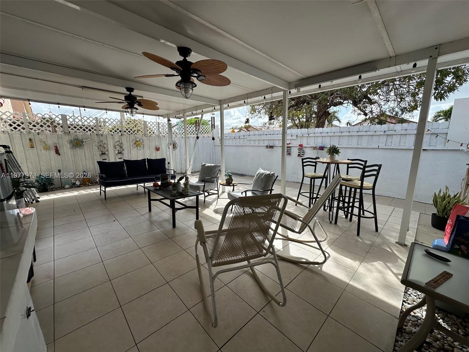 2385 West 69th Street, Unit 2385A Hialeah, FL 33016 - Photo 22 of 22 a view of a patio with table and chairs