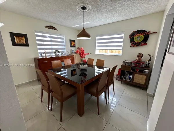 a dining room with furniture and window