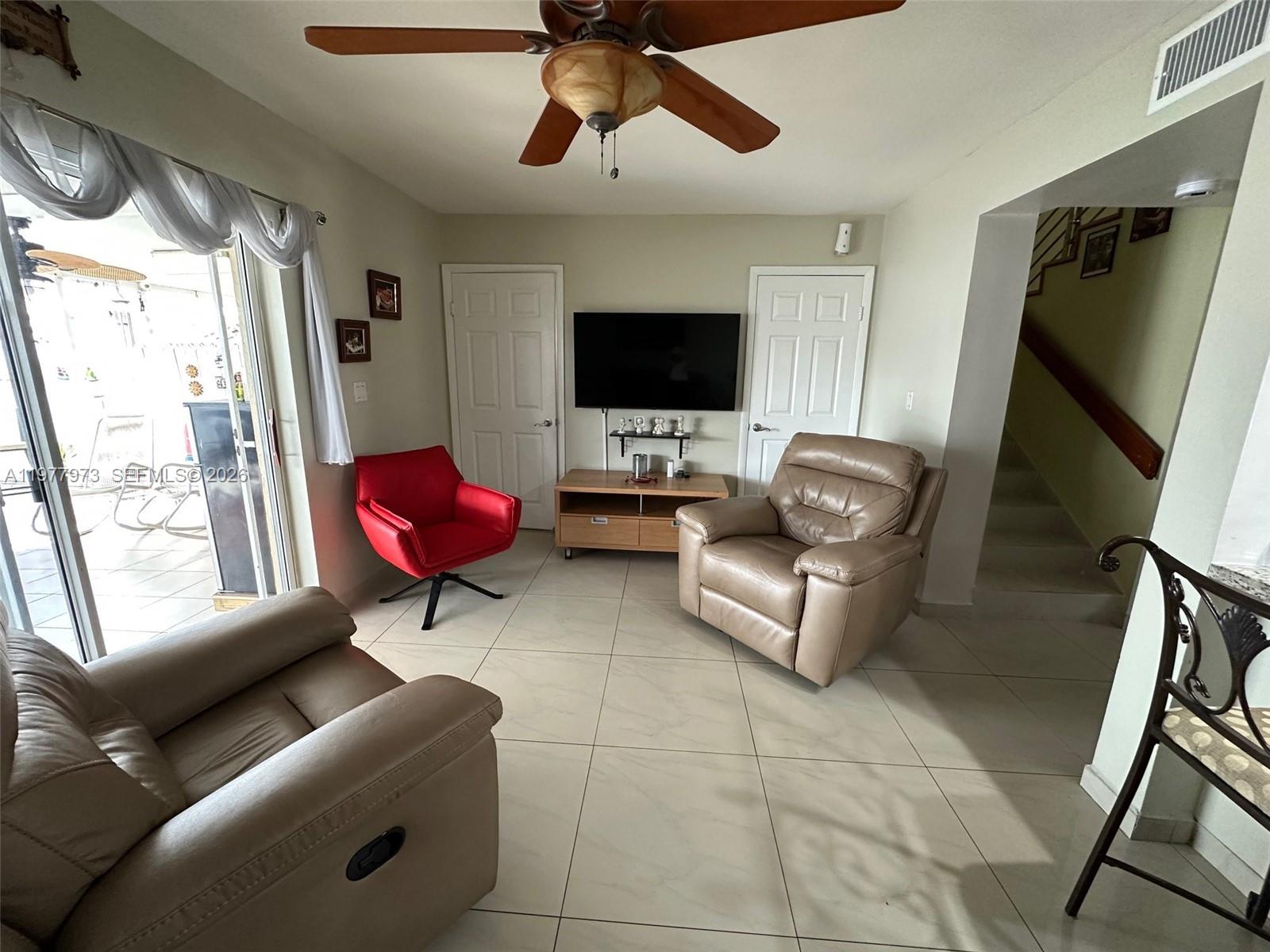2385 West 69th Street, Unit 2385A Hialeah, FL 33016 - Photo 8 of 22 a living room with furniture or couch and a flat screen tv