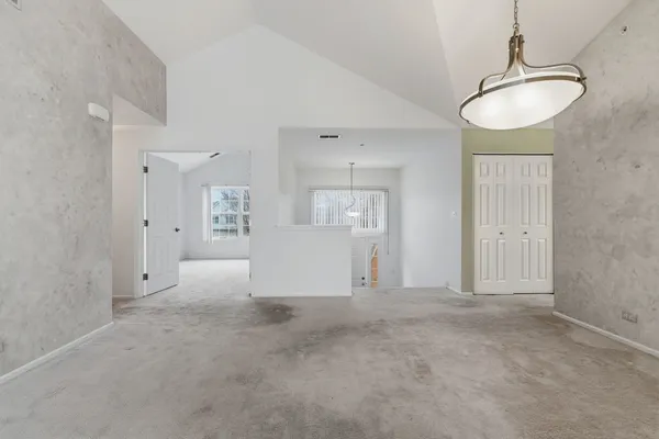 a view of a kitchen with refrigerator and window