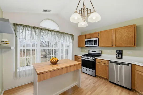 a kitchen with a sink appliances and cabinets