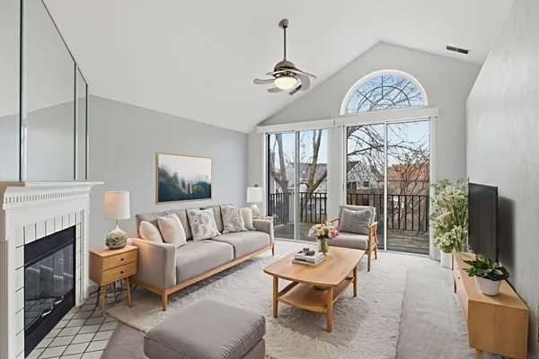 a living room with furniture a fireplace and a flat screen tv
