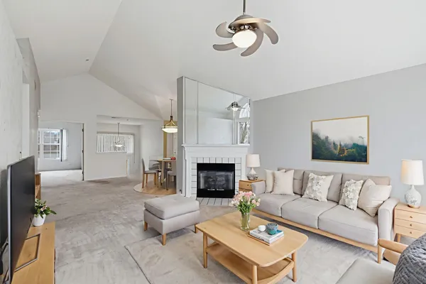 a living room with furniture a fireplace and a flat screen tv