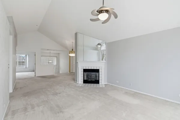 a view of a livingroom with a fireplace and window