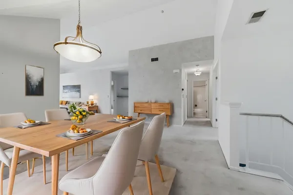 a dining room with furniture and a chandelier